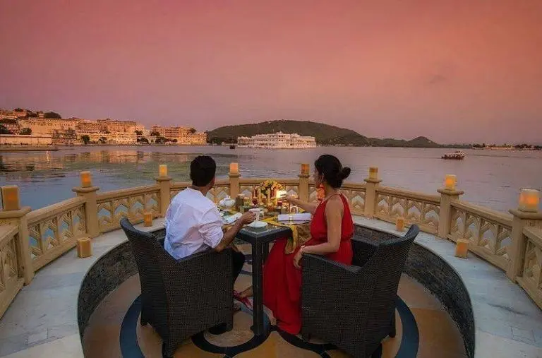 A couple enjoying an evening date with an stunning view of pichola lake, udaipur